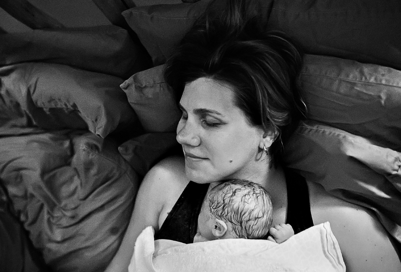 Image of a mother with her newborn resting on her chest.