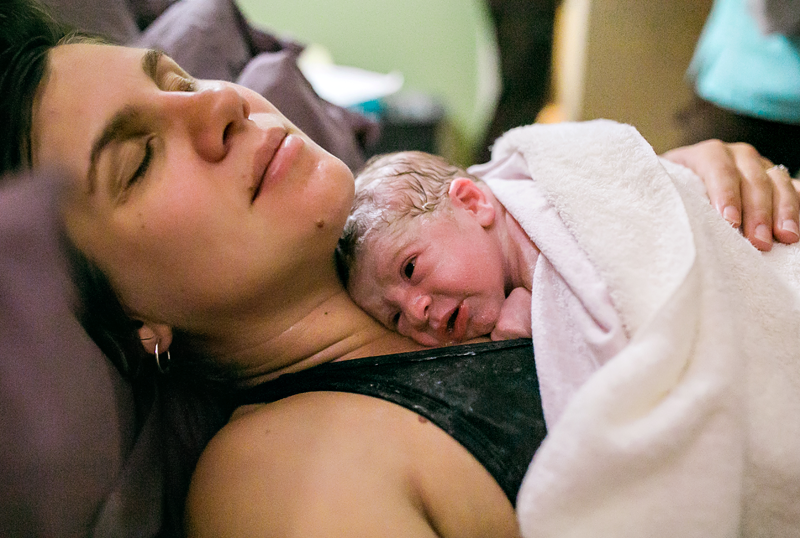 Image of a mother with newborn baby resting on her chest.