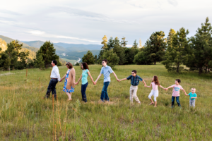Family of eight walking with Colorado mountain view.